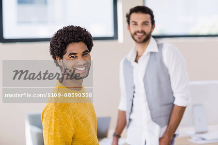 Smiling man with partner in background