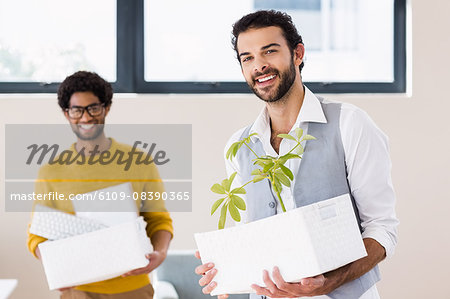 Happy gay couple holding white boxes