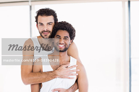 Smiling gay couple hugging