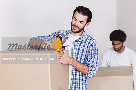 Gay couple closing and holding big boxes