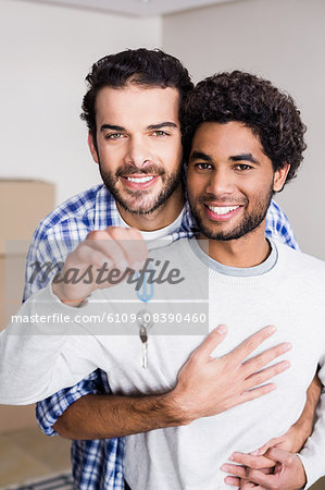 Happy gay couple holding new house keys