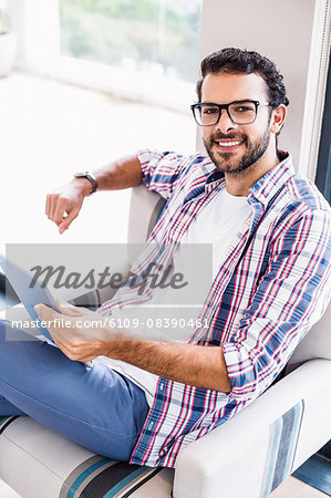 Portrait of smiling man using tablet