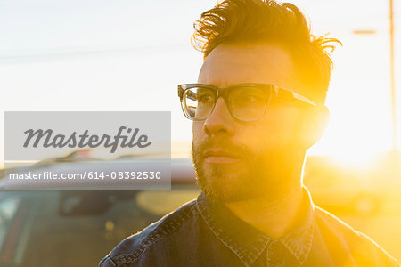 Portrait of young man, outdoors, bright sunlight