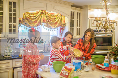 Mother and children in kitchen, baking