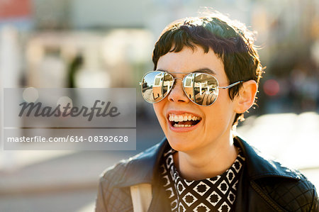 Portrait of mid adult woman, outdoors, wearing mirrored sunglasses