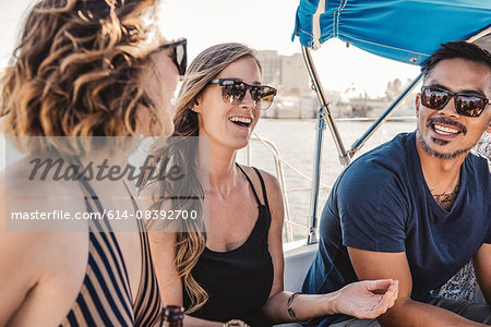 Friends chatting on sailboat, San Diego Bay, California, USA