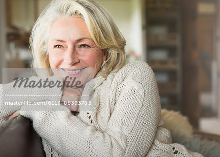 Smiling senior woman in sweater looking away