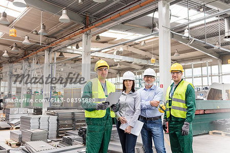 Portrait confident engineers and workers in steel factory