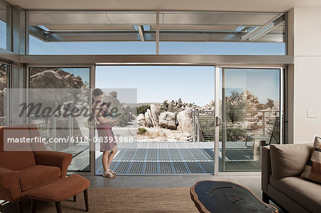 A woman and a young child in the living space of an eco house in the desert.