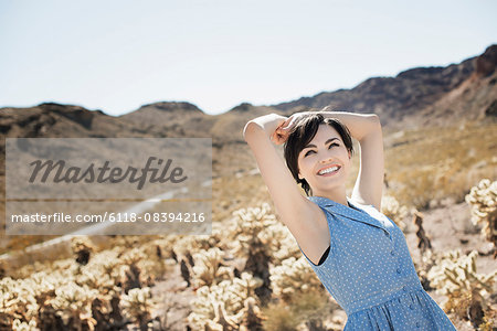 A young woman in a desert landscape.