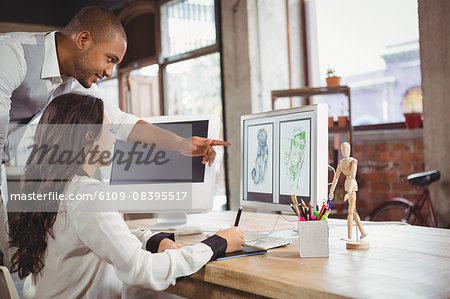 Man pointing at design and showing to woman