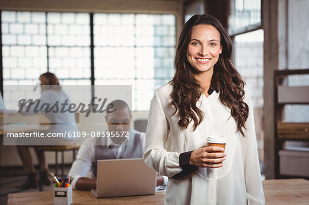 Portrait of smiling woman holding coffee