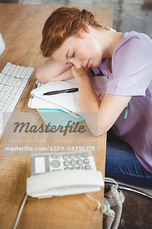 High angle view of businesswoman sleeping on desk