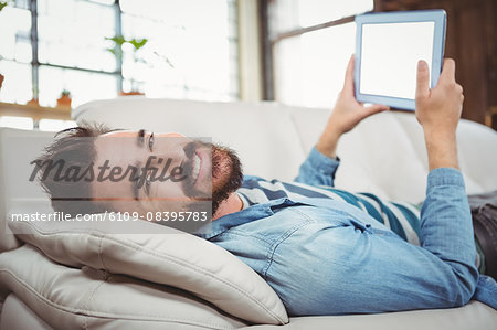 Portrait of happy man holding digital tablet