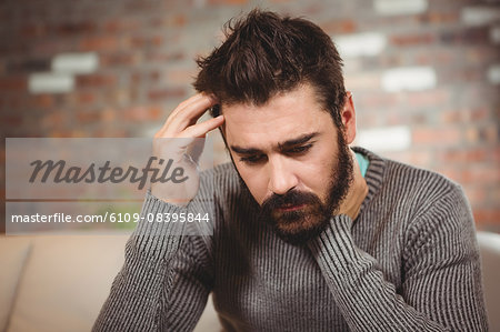 Close-up of stressed man with hand on head