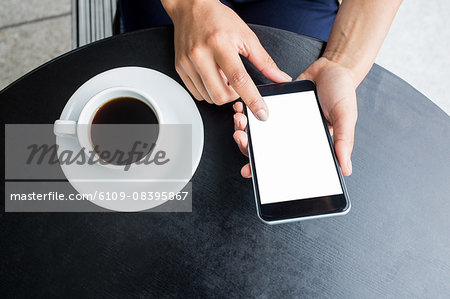 Student using her phone in cafe