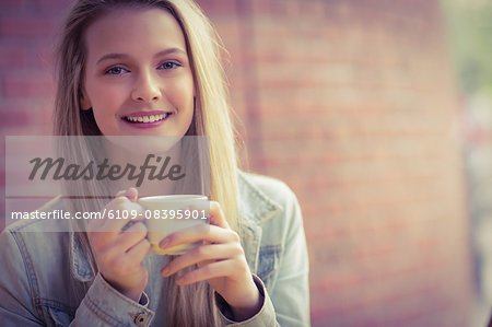 Pretty student having a coffee