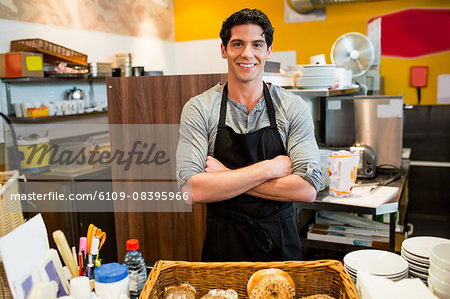 Handsome waiter smiling at camera