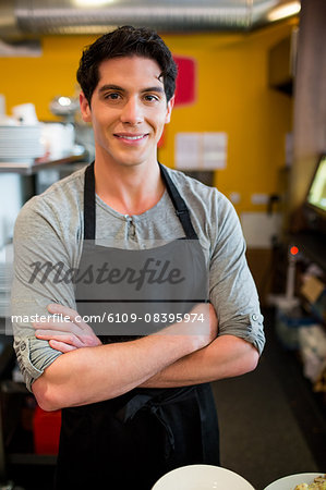 Handsome waiter smiling at camera