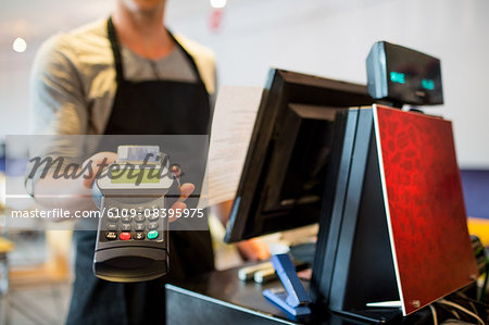 Waiter offering pin pad to camera