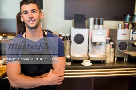 Handsome waiter smiling at camera