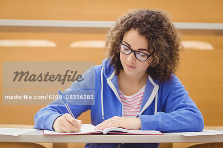 Focused student taking notes in lecture
