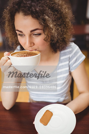 Pretty student having a coffee