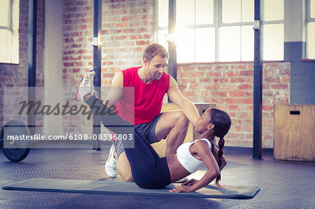 Muscular couple doing a leg stretching