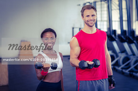 Muscular couple lifting weight together