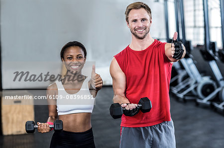 Muscular couple lifting weight together