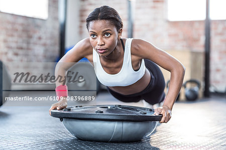 Muscular focused woman doing fitness workout Muscular focused woman doing fitness workout