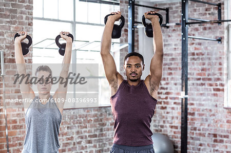 Fit couple lifting kettle bells