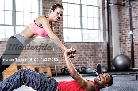 Fit couple doing core exercises