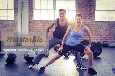 Fit couple doing stretching exercises