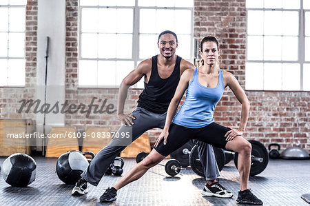 Fit couple doing stretching exercises Fit couple doing stretching exercises