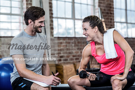 Smiling woman doing dumbbell exercises