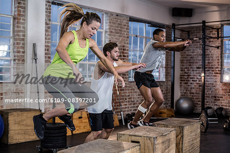 Three fit athletes doing exercises