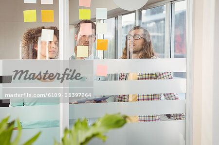 Business people looking at sticky notes