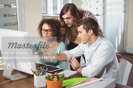 Business people discussing over computer