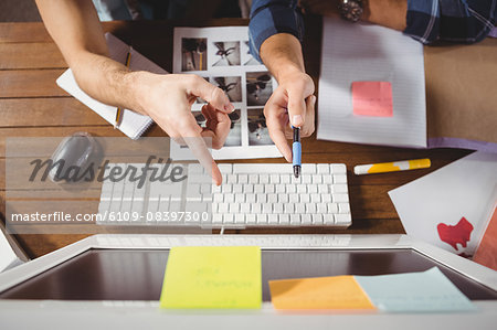 Businessmen pointing at computer screen