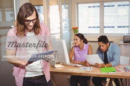 Creative businessman using digital tablet in office