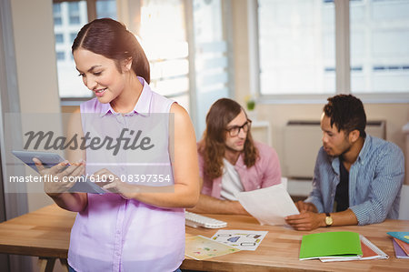 Creative businesswoman using digital tablet in office