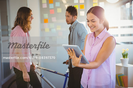 Happy creative businesswoman using digital tablet