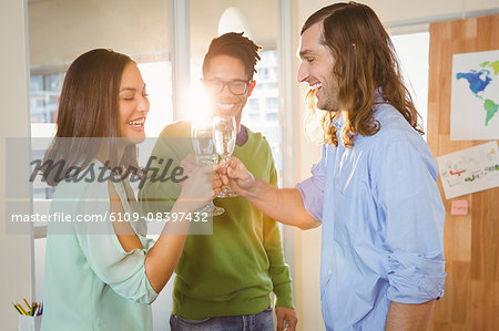 Business people toasting during celebration in creative office