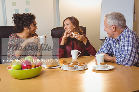 Business people having breakfast at office