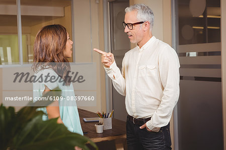 Businessman pointing at colleague while discussion