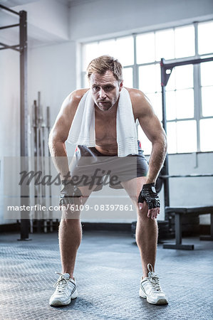 Fit man with towel on shoulders