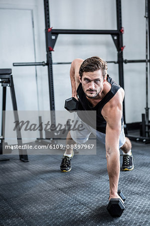 Fit man working out with dumbbells