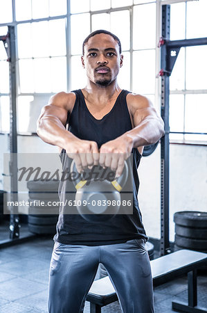 Fit man working out with kettlebell