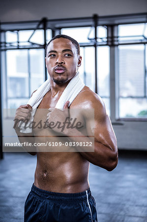 Fit shirtless man with towel on shoulders